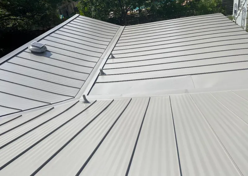 Solar attic fan installed on a metal roof for Roof Ventilation in Dakota Ridge